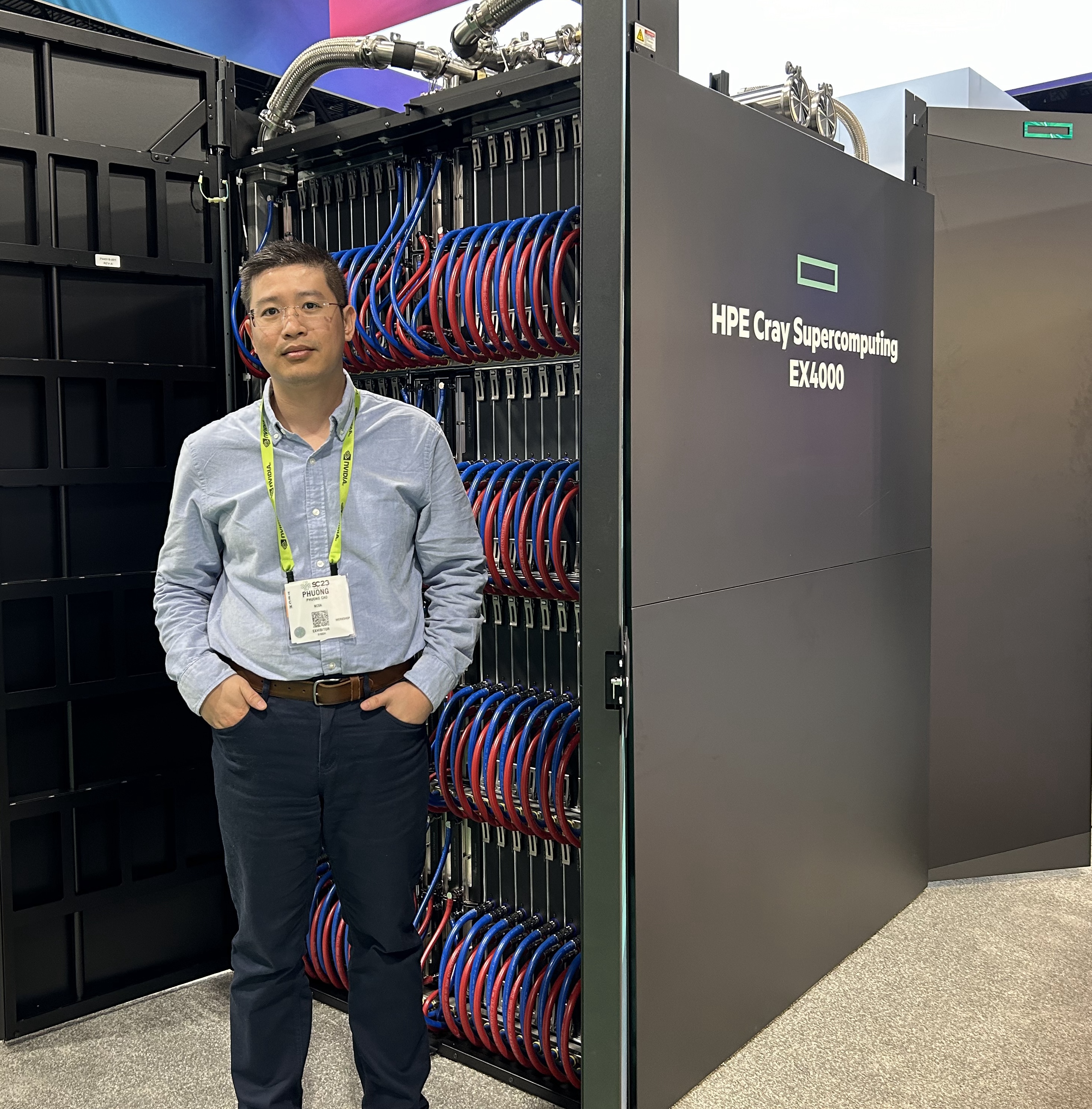 Phuong Cao with HPE Cray Supercomputer Exascale cabinet