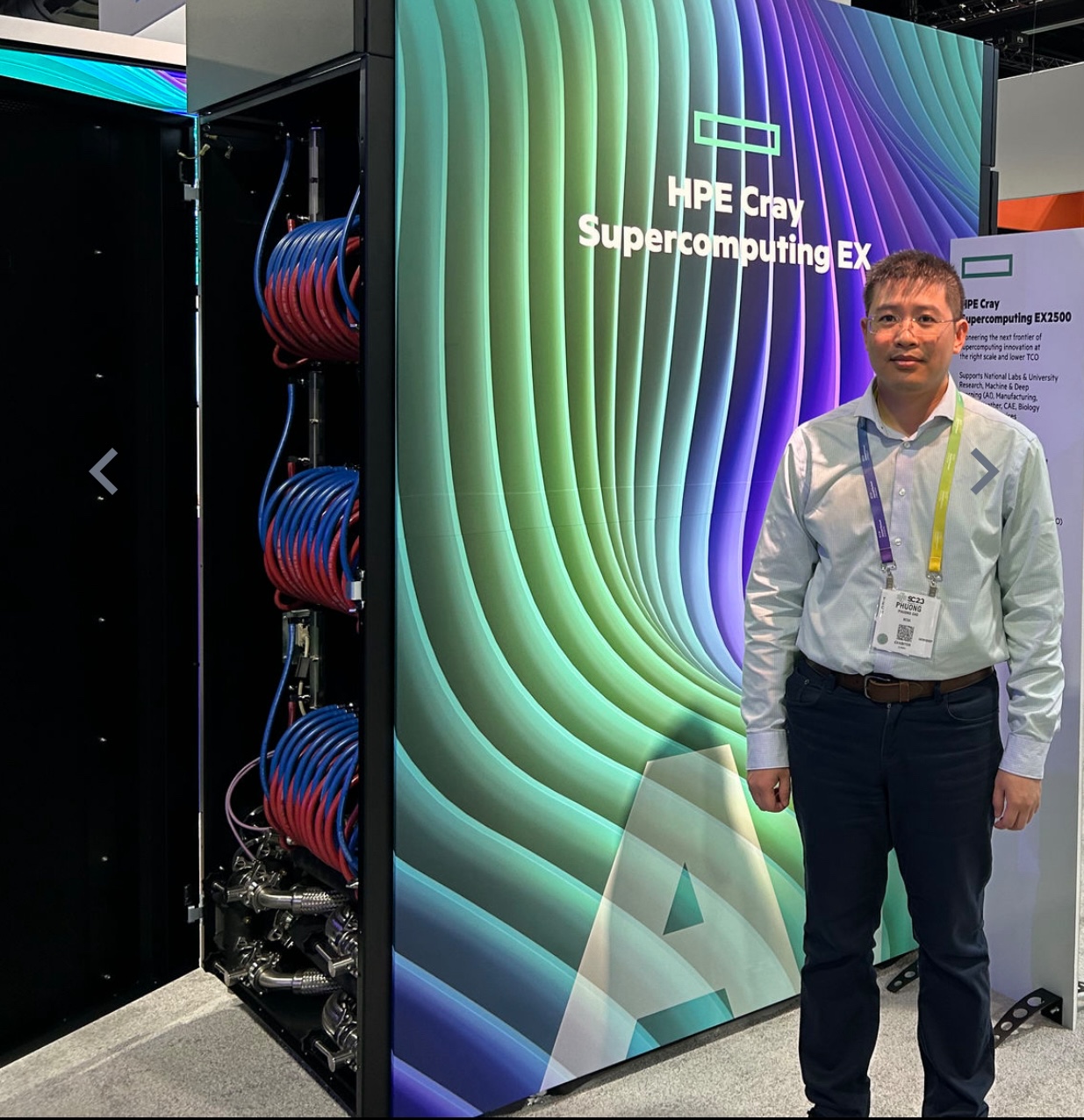 Phuong Cao with HPE Cray Supercomputer Exascale cabinet